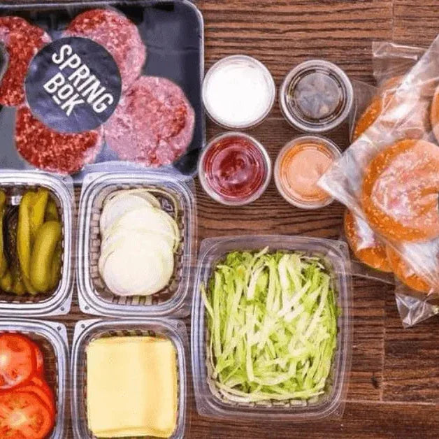 Springbok Burger Box - 12 SOFT BUNS, 12 BEEF PATTIES, 1 KG POTATO WEDGES & Lettuce, Tomatoes, Onions, Cheddar Cheese Slices, Pickles, Springbok's Famous Sauce, Tomato Relish Dressing. - Springbok Butchery